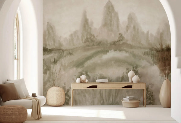 Papel tapiz mural con paisaje pictórico difuminado en tonos verde salvia y beige sobre pared de sala luminosa